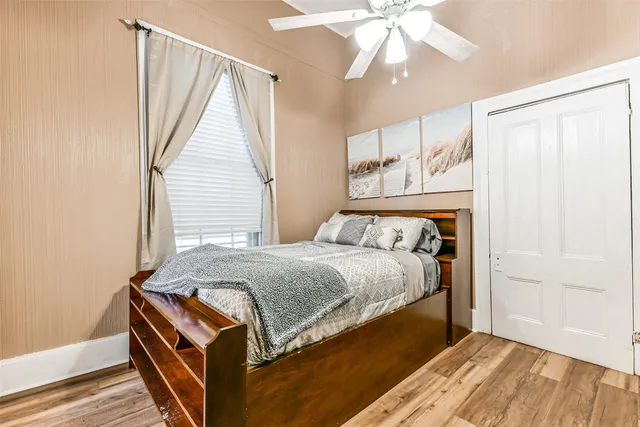 a bed sitting in a bedroom next to a window