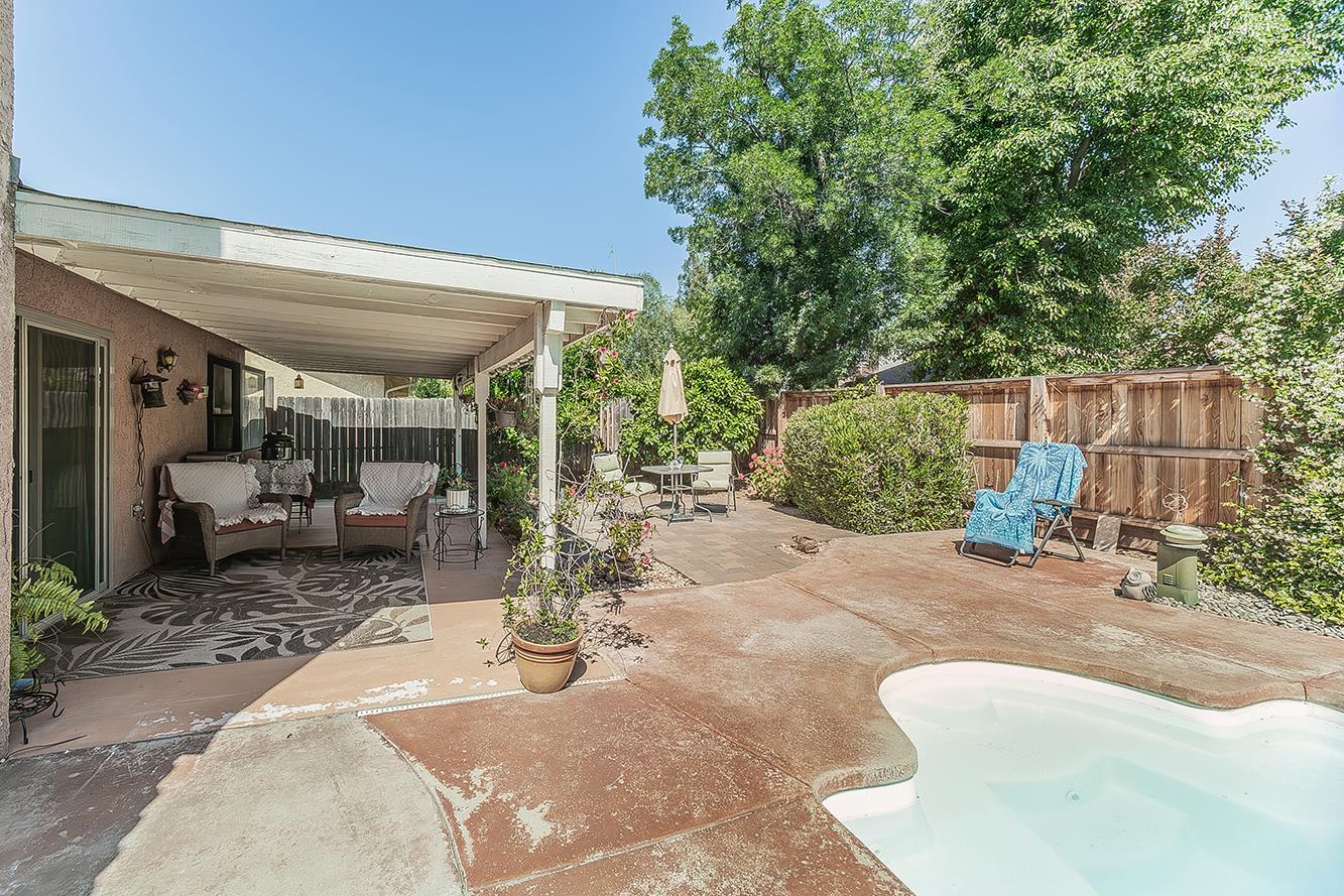 1908 East Niles Avenue Fresno, CA 93720 - Photo 27 of 30 a view of a patio with table and chairs potted plants and large tree