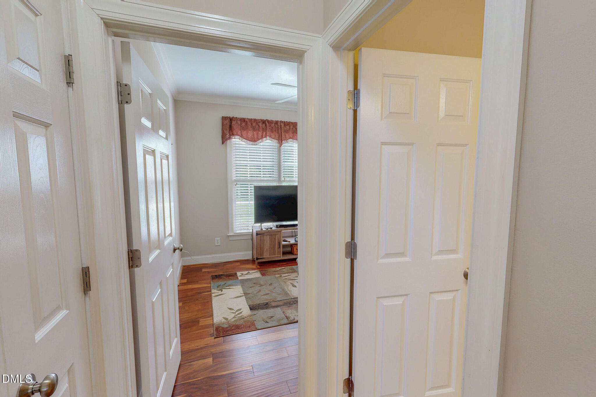 115 Duncan Plantation Road Timberlake, NC 27583 - Photo 36 of 48 a view of a hallway with wooden floor fireplace and living room