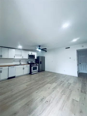 a view of a kitchen with a sink and a stove top oven