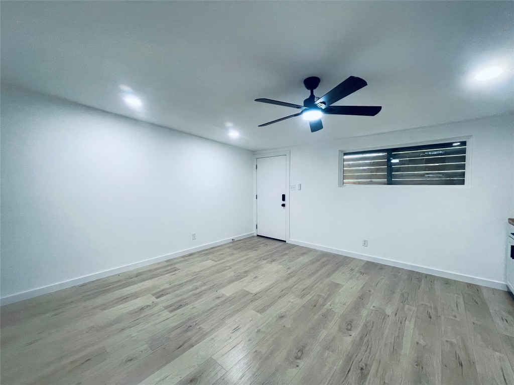 7107 Guadalupe Street, Unit 202 Austin, TX 78752 - Photo 4 of 8 Unfurnished room featuring light wood finished floors and ceiling fan