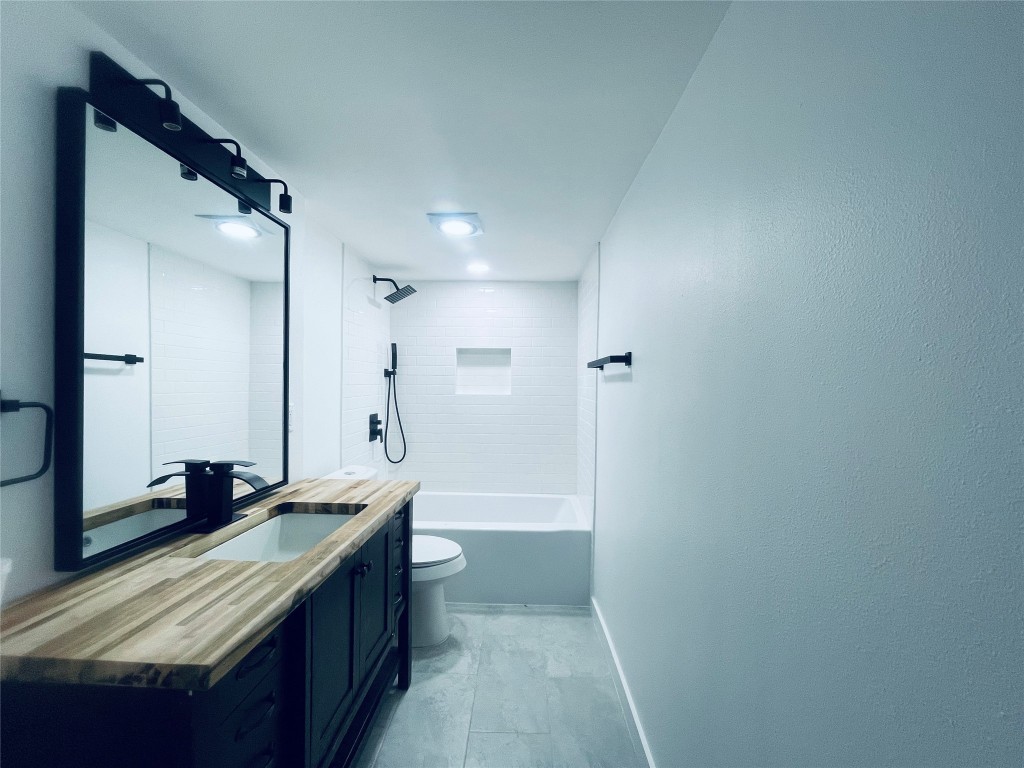 7107 Guadalupe Street, Unit 202 Austin, TX 78752 - Photo 6 of 8 Full bath with shower / tub combination and vanity