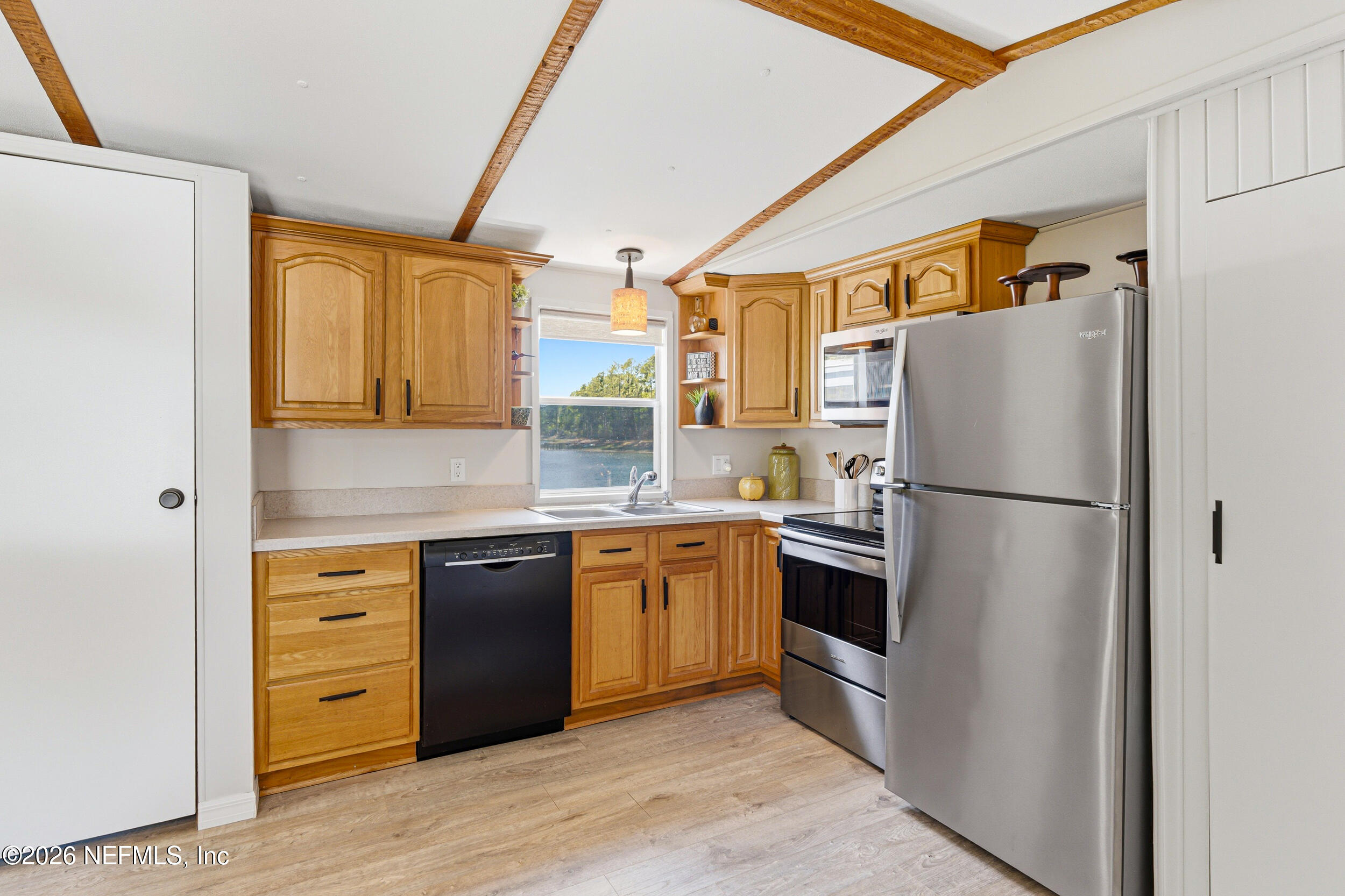 115 Lake Susan Road Hawthorne, FL 32640 - Photo 12 of 62 a kitchen with a refrigerator cabinets and wooden floor
