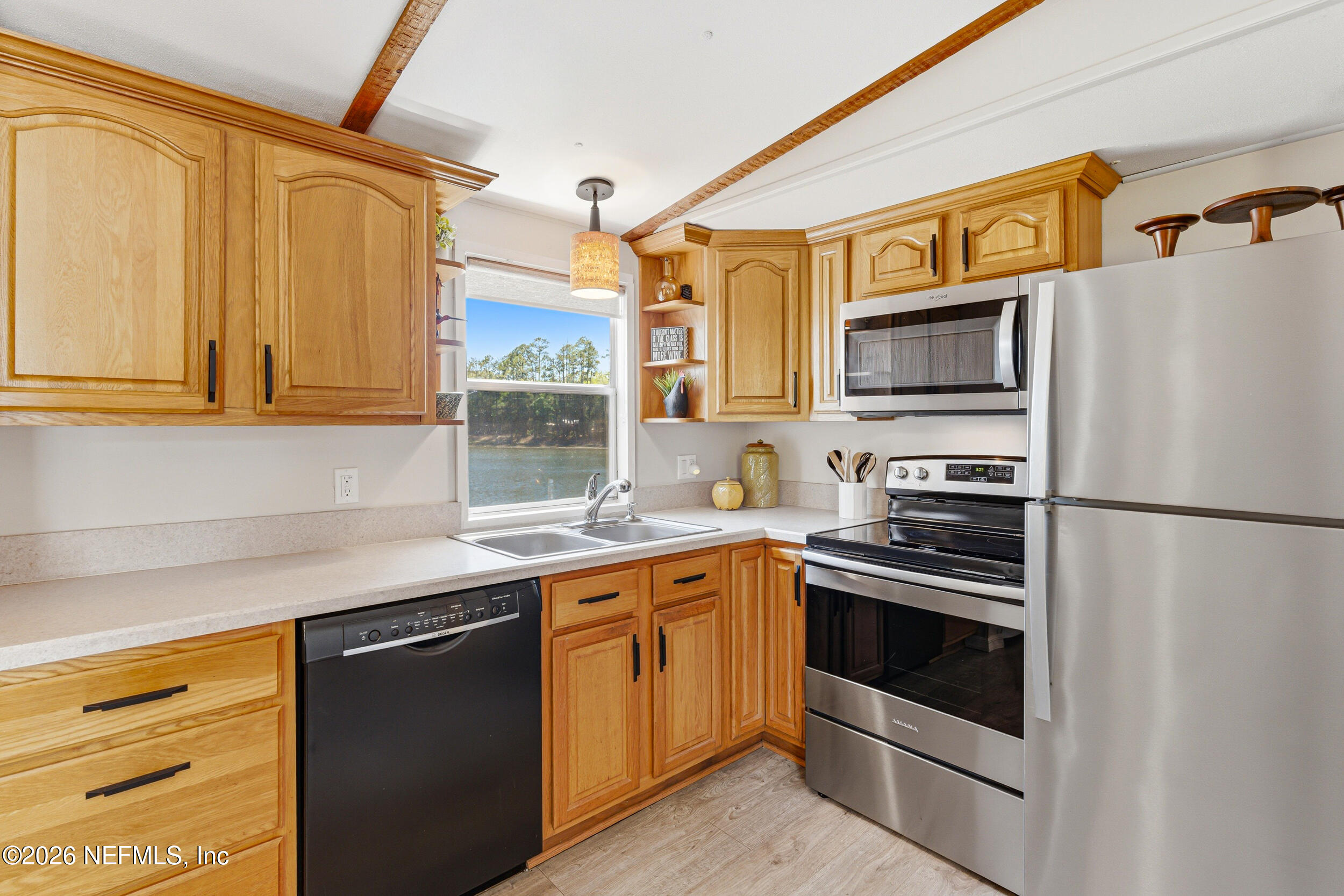 115 Lake Susan Road Hawthorne, FL 32640 - Photo 13 of 62 a kitchen with stainless steel appliances granite countertop a stove a sink and a refrigerator