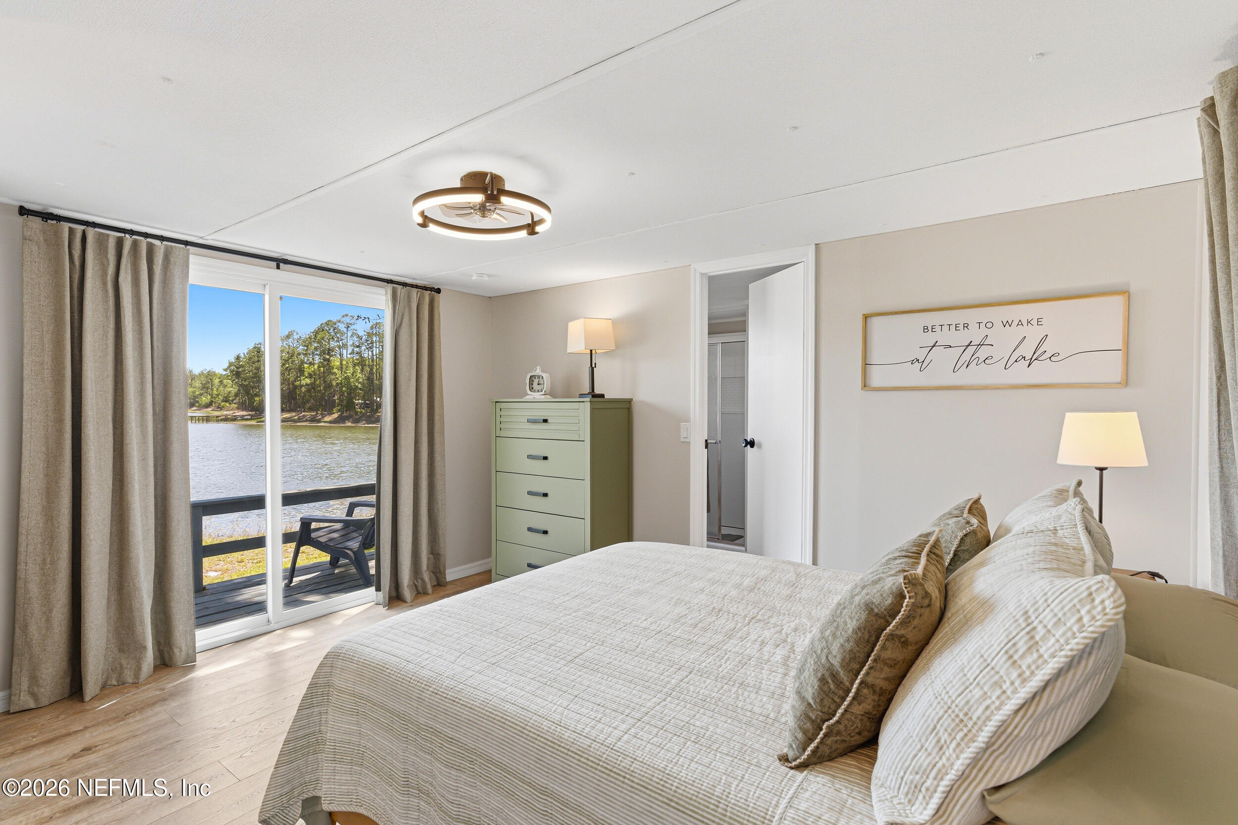 115 Lake Susan Road Hawthorne, FL 32640 - Photo 14 of 62 a bedroom with a bed and a large window