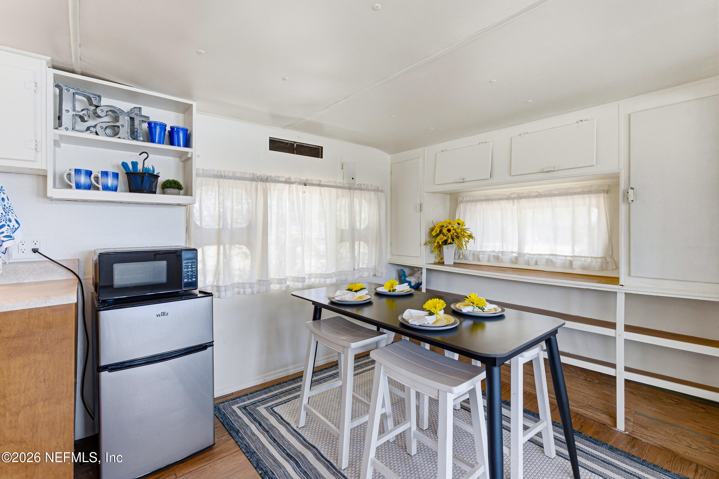 115 Lake Susan Road Hawthorne, FL 32640 - Photo 26 of 62 a kitchen with stainless steel appliances granite countertop a table chairs and a refrigerator