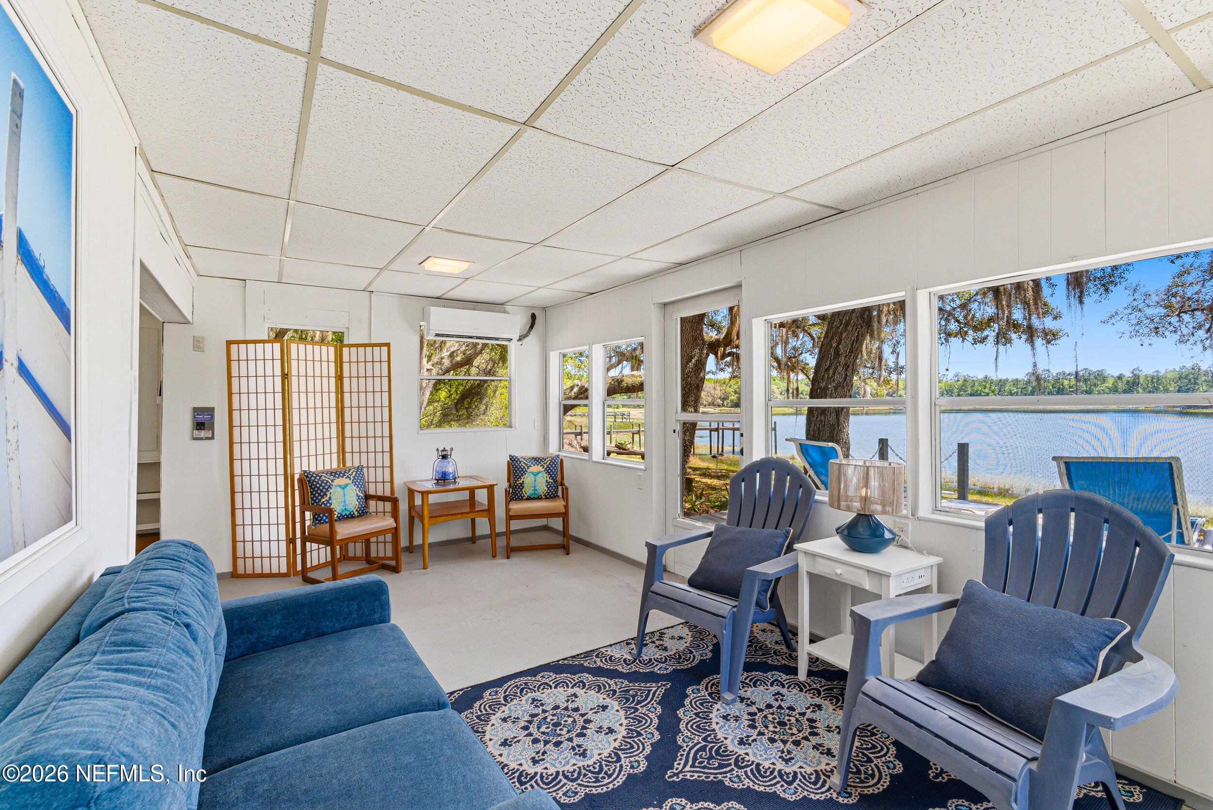 115 Lake Susan Road Hawthorne, FL 32640 - Photo 27 of 62 a living room with furniture and a floor to ceiling window