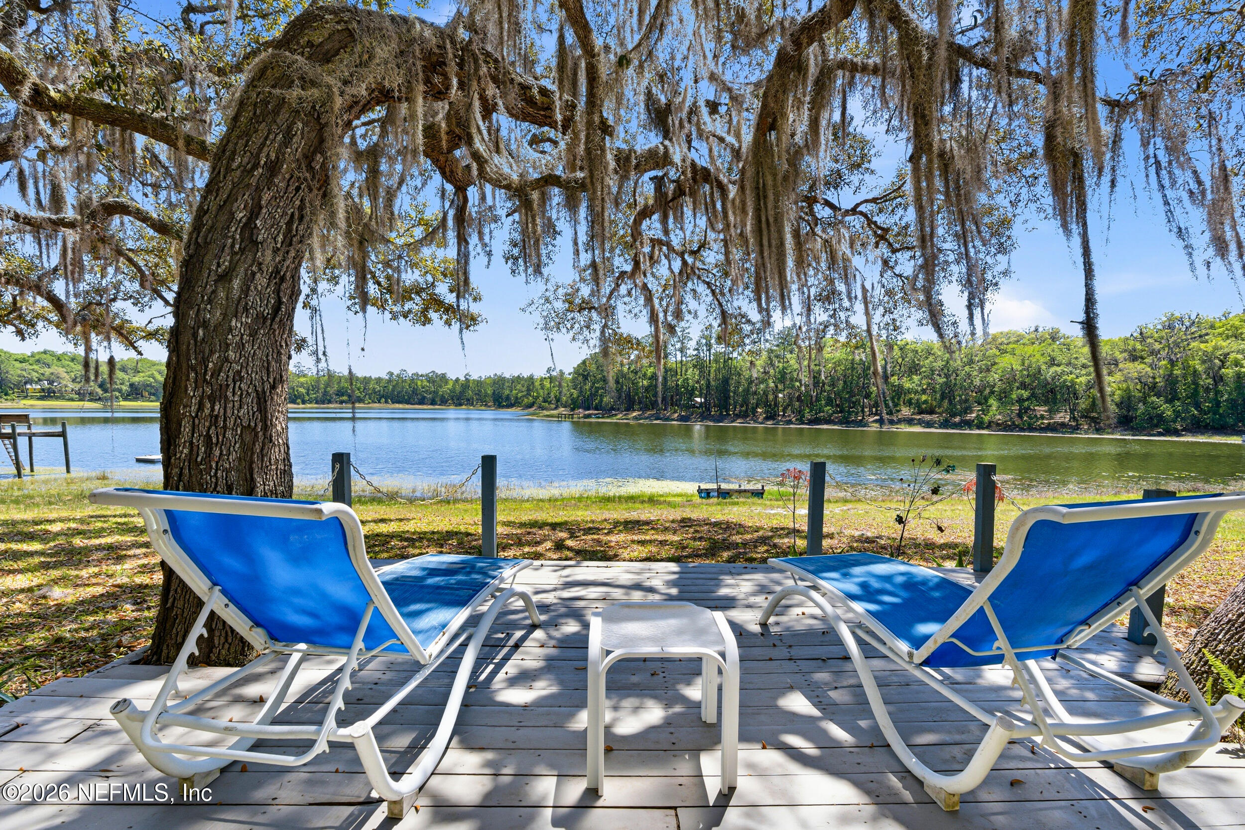 115 Lake Susan Road Hawthorne, FL 32640 - Photo 35 of 62 a view of a lake with couches chairs and a yard