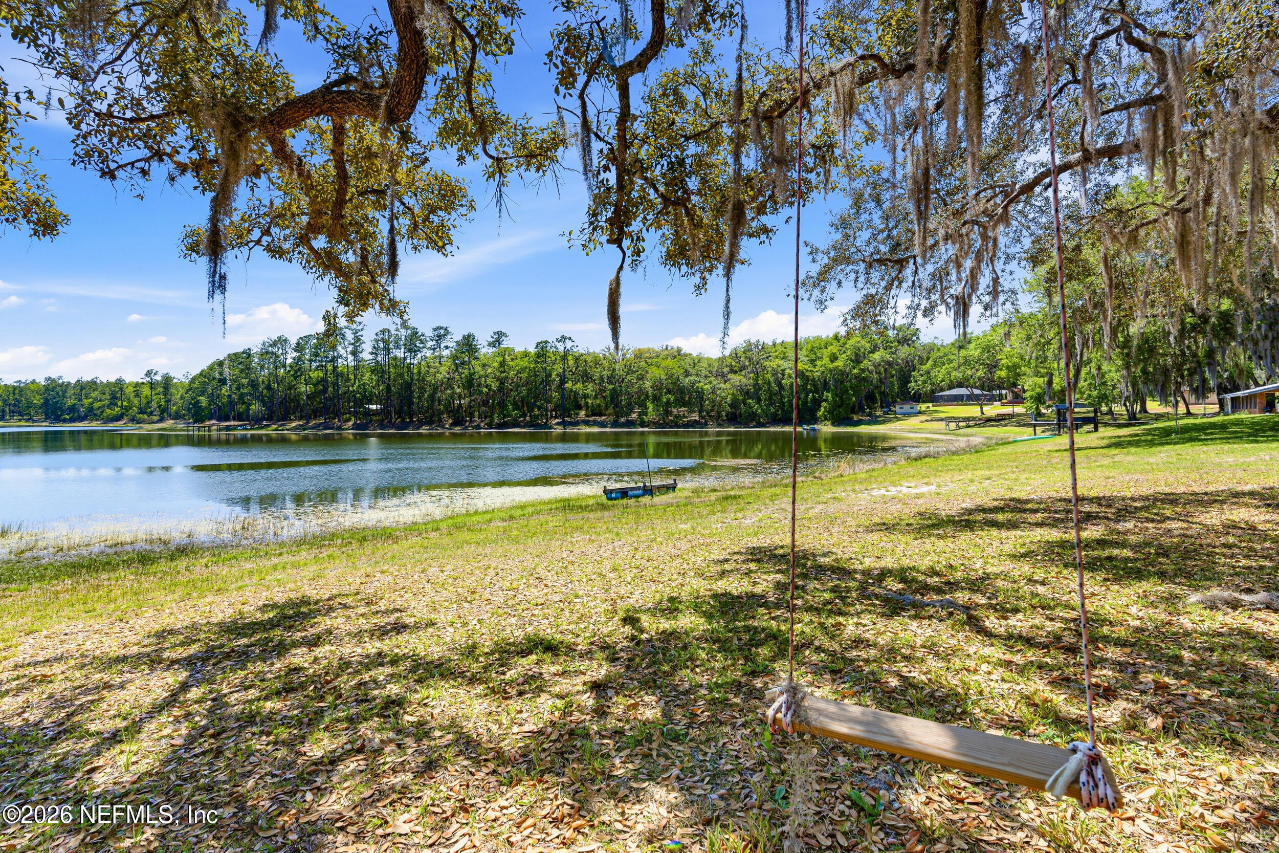 115 Lake Susan Road Hawthorne, FL 32640 - Photo 42 of 62 a view of a swimming pool with an outdoor space and seating area