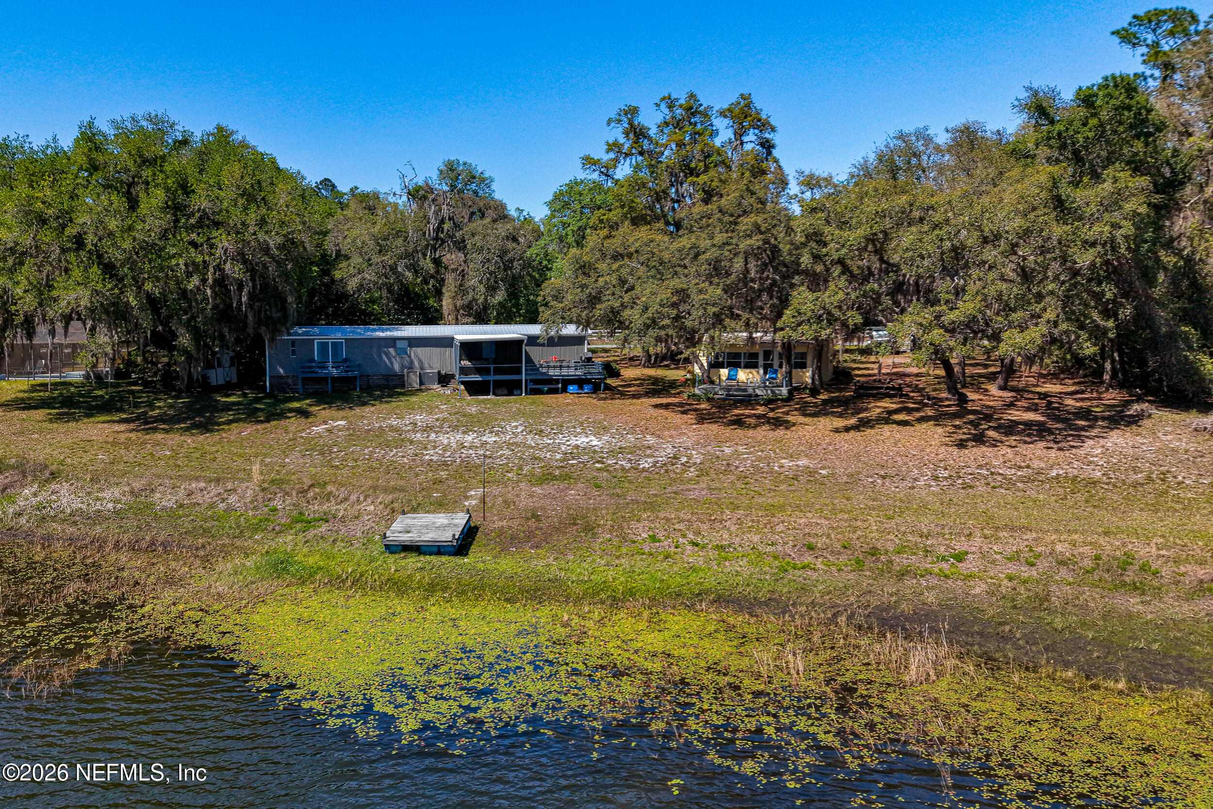 115 Lake Susan Road Hawthorne, FL 32640 - Photo 58 of 62 a backyard of a house with table and chairs