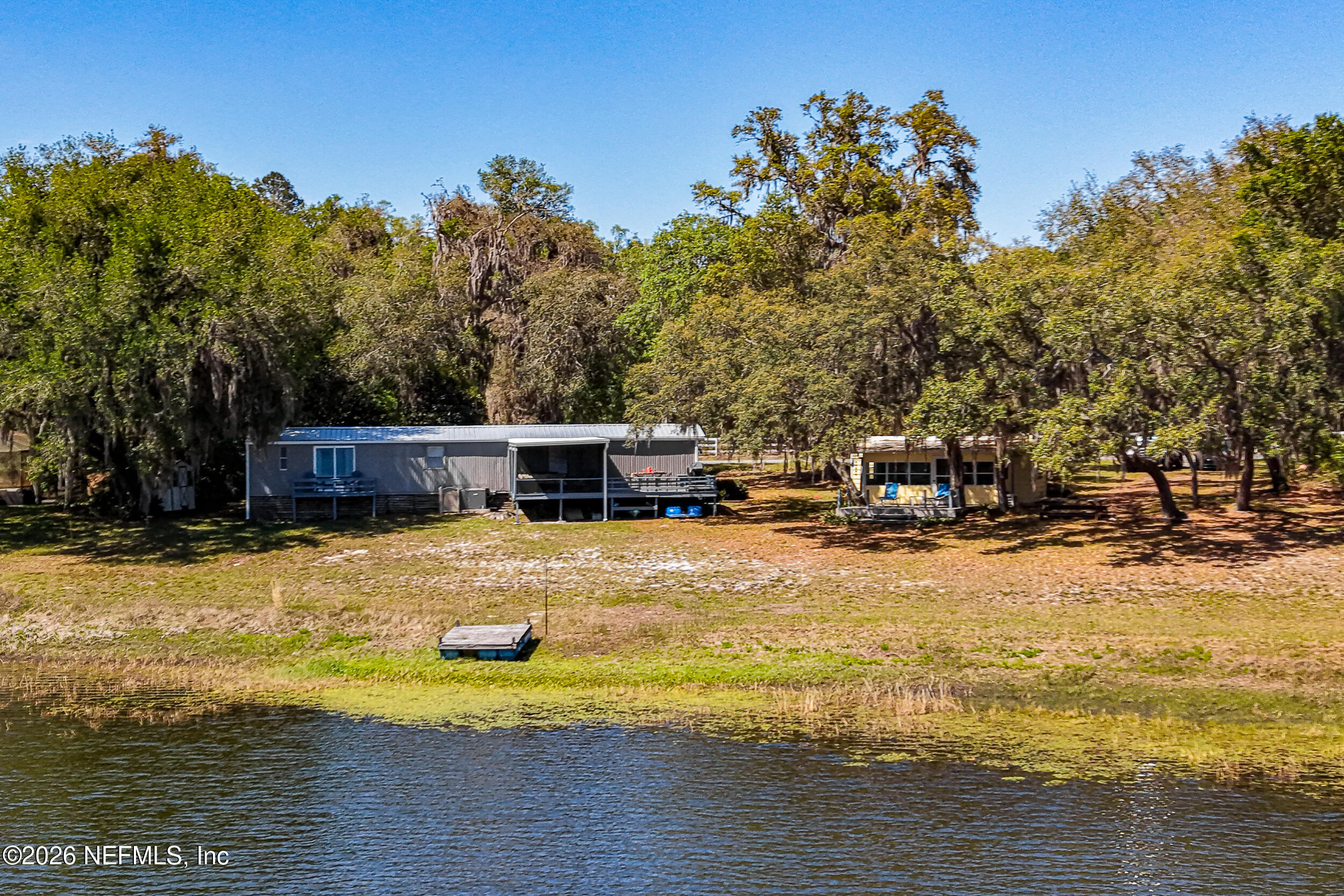 115 Lake Susan Road Hawthorne, FL 32640 - Photo 59 of 62 a swimming pool with outdoor seating and yard