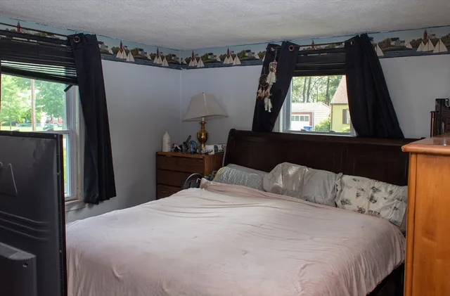 a bedroom with a bed and a window