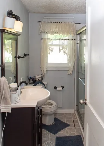 a bathroom with a sink toilet and shower