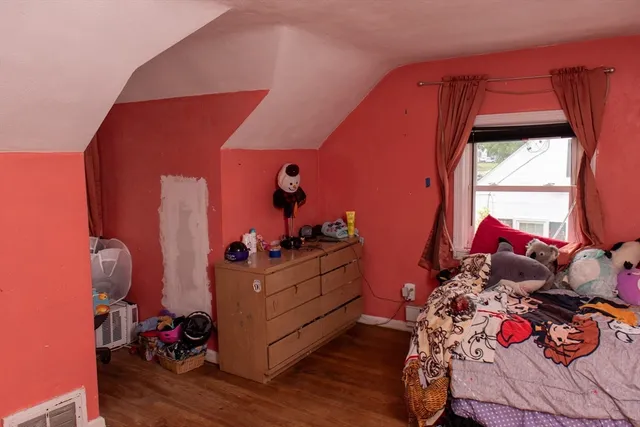 a bed room with a bed and a window