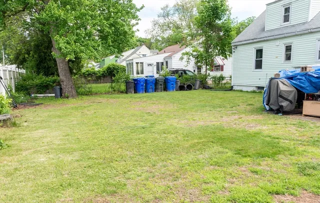 a view of a house with backyard and sitting area