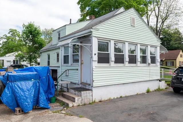 a view of a house with a large windows and a yard