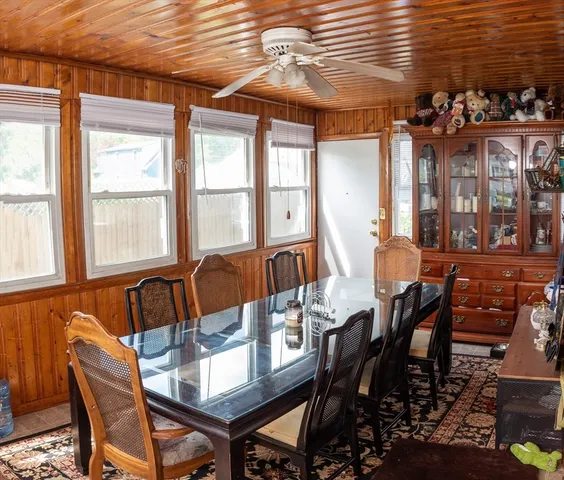 a view of a dining room with furniture and chandelier