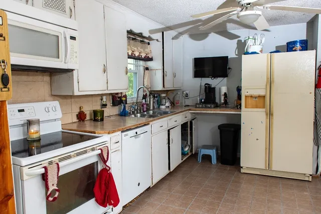 a kitchen with a sink a stove and a microwave