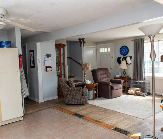 a living room with furniture and a mirror