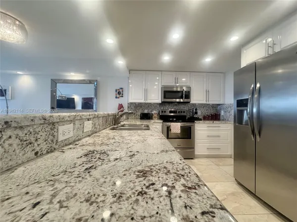 a kitchen with a refrigerator sink and microwave