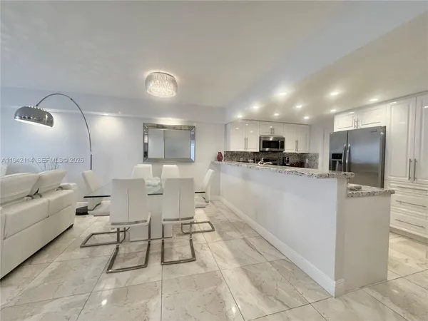 a living room with furniture and a mirror