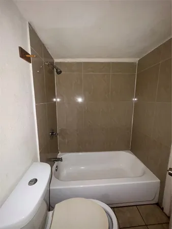 a bathroom with a toilet and a bathtub