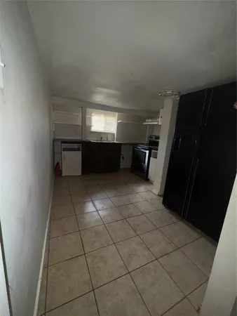 a view of a utility room with a refrigerator