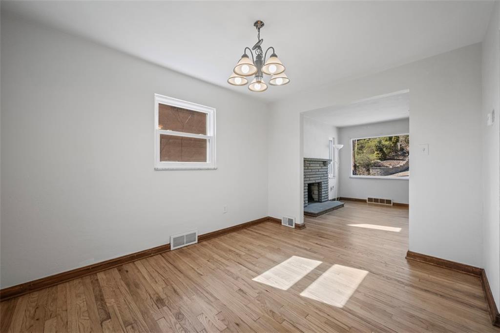 259 Bascom Avenue Pittsburgh, PA 15214 - Photo 11 of 35 a view of an empty room with a window and wooden floor