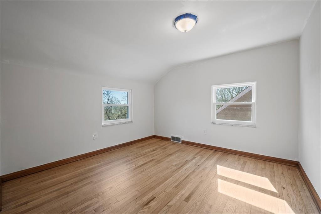 259 Bascom Avenue Pittsburgh, PA 15214 - Photo 27 of 35 a view of an empty room with wooden floor and a window