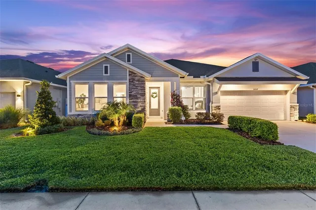 a living room with kitchen island furniture and a chandelier