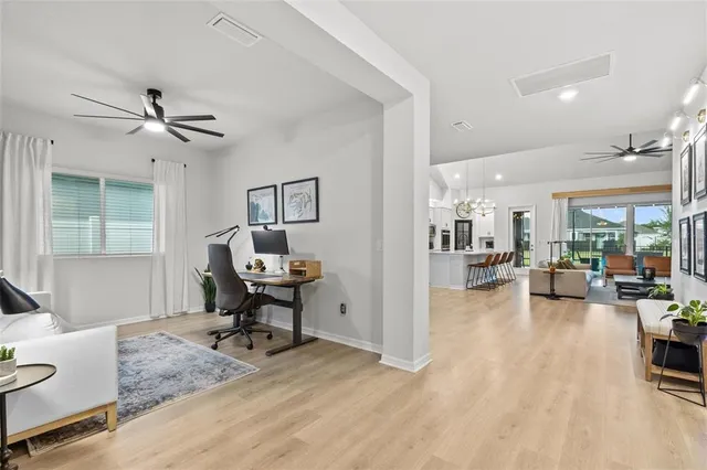 a living room with stainless steel appliances kitchen island granite countertop furniture and a rug