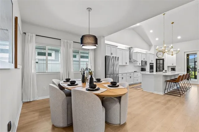 a kitchen with stainless steel appliances white cabinets and a sink