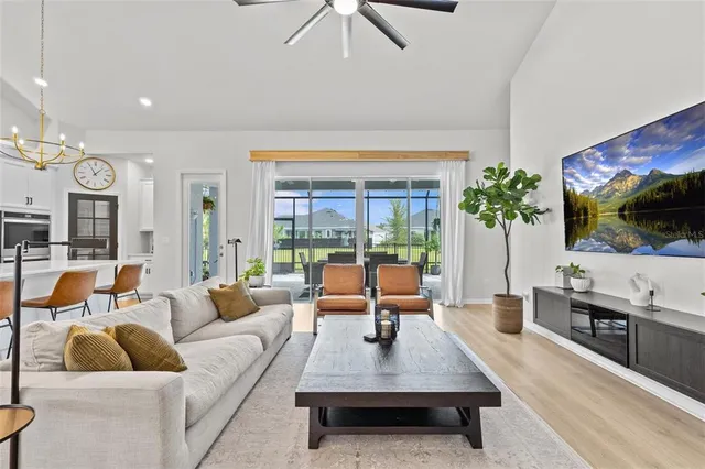 a bedroom with a bed a couch and a flat screen tv