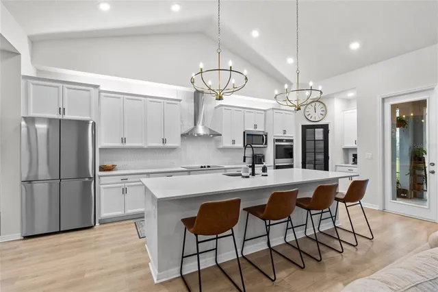 a view of a livingroom with furniture and a hallway
