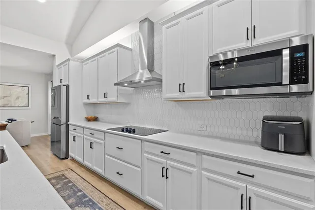 a bathroom with a toilet a sink a mirror a vanity and shower