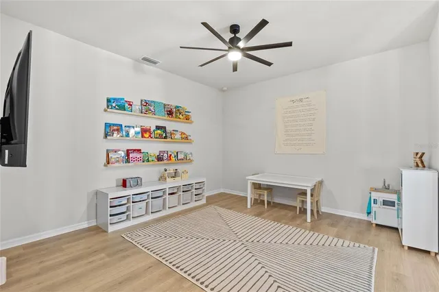 a view of a bedroom with furniture and window
