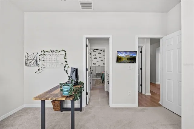 a picture of a room with a white wall and a large window