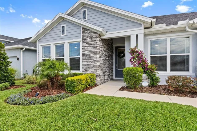a dining room with furniture a window and potted plants