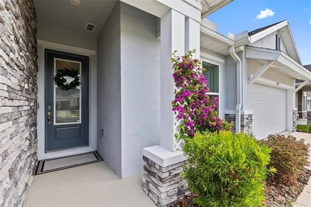 a kitchen with stainless steel appliances kitchen island granite countertop a stove a sink a dining table and chairs