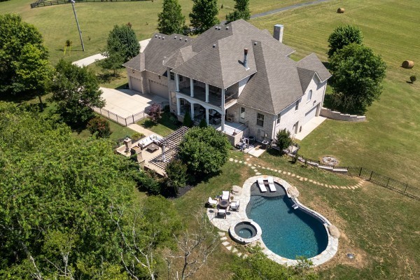 an aerial view of a house with yard swimming pool and outdoor seating