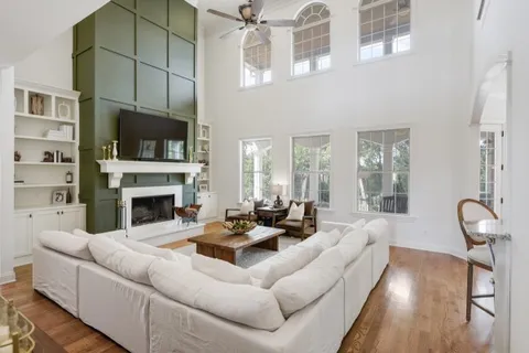 a living room with furniture fireplace and a flat screen tv