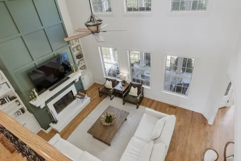 a living room with furniture fireplace and flat screen tv