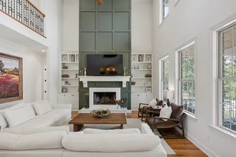 a very nice looking kitchen with granite countertop a large window a sink stainless steel appliances and cabinets
