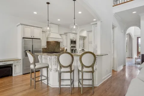 a kitchen with stainless steel appliances granite countertop a stove sink and cabinets