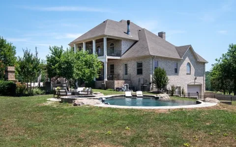 a front view of a house with sitting area