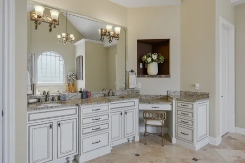 a living room with furniture a flat screen tv and a refrigerator