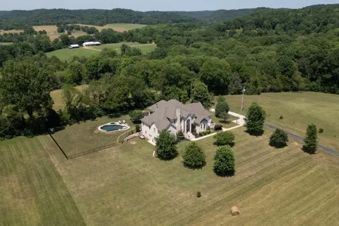 an aerial view of a house with yard