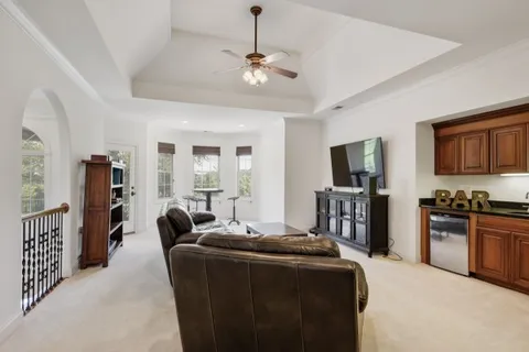 a balcony with wooden floor and outdoor seating