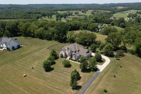 an aerial view of a house with yard
