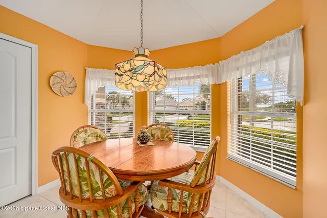 a living room with furniture a fireplace and large windows